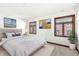 Bright bedroom with a queen-size bed and two pieces of artwork at 1521 N Alabama St # L, Indianapolis, IN 46202