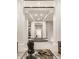Two-story entryway with a grand staircase and white columns at 9468 Sullivan Pl, Zionsville, IN 46077