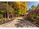 Cobblestone driveway winding through a colorful autumn landscape at 9468 Sullivan Pl, Zionsville, IN 46077