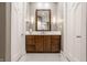 Modern bathroom with a wood vanity and white tile flooring at 9468 Sullivan Pl, Zionsville, IN 46077