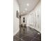 Modern hallway with curved walls, dark floors, and artwork at 9468 Sullivan Pl, Zionsville, IN 46077