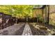 Landscaped backyard with a stone path and Japanese-style gate at 9468 Sullivan Pl, Zionsville, IN 46077