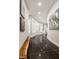 Modern hallway with curved walls, dark floors, and artwork at 9468 Sullivan Pl, Zionsville, IN 46077