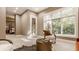 Cozy sitting area with large windows, comfortable chair and a coffee table at 9468 Sullivan Pl, Zionsville, IN 46077