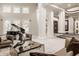Elegant living room with high ceilings, grand staircase, and large windows at 9468 Sullivan Pl, Zionsville, IN 46077