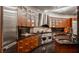 Modern kitchen with curved cabinetry, stainless steel appliances, and granite countertops at 9468 Sullivan Pl, Zionsville, IN 46077