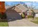 House exterior with landscaping and garage at 8704 Quarterhorse Dr, Indianapolis, IN 46256