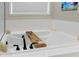 Soaking tub with tray, candles, and subway tile surround at 12594 Tidecrest Dr, Fishers, IN 46037