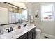 Bathroom with double vanity, large mirror, and shower/tub combo at 12594 Tidecrest Dr, Fishers, IN 46037