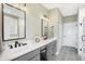 Elegant bathroom with double vanity, large mirror, and patterned floor at 12594 Tidecrest Dr, Fishers, IN 46037