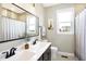 Bathroom with double vanity, large mirror, and shower/tub combo at 12594 Tidecrest Dr, Fishers, IN 46037