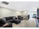 Large bonus room featuring a sectional sofa and a home office area at 12594 Tidecrest Dr, Fishers, IN 46037