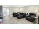 Comfortable bonus room with sectional sofa and recliner at 12594 Tidecrest Dr, Fishers, IN 46037