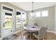 Bright breakfast nook with round table, four chairs, and view of backyard at 12594 Tidecrest Dr, Fishers, IN 46037