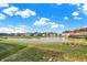 Community pond with walking path and autumn foliage at 12594 Tidecrest Dr, Fishers, IN 46037