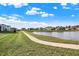 Community pond with walking path and homes at 12594 Tidecrest Dr, Fishers, IN 46037