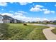 A paved path winds beside a pond, offering scenic community views at 12594 Tidecrest Dr, Fishers, IN 46037