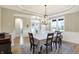 Bright dining room with chandelier, hardwood floors, and access to kitchen at 12594 Tidecrest Dr, Fishers, IN 46037