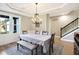Elegant dining room features a chandelier, large windows, and hardwood floors at 12594 Tidecrest Dr, Fishers, IN 46037
