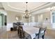 Spacious dining room with chandelier, hardwood floors, and views to backyard at 12594 Tidecrest Dr, Fishers, IN 46037