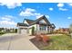 House exterior with gray and white siding, stone accents, and a two-car garage at 12594 Tidecrest Dr, Fishers, IN 46037