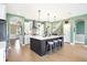 Open kitchen with white cabinets, large island, and a farmhouse sink at 12594 Tidecrest Dr, Fishers, IN 46037