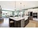 Open concept kitchen with large island, white cabinets, and a view of the living area at 12594 Tidecrest Dr, Fishers, IN 46037