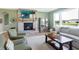 Relaxing living room with a stone fireplace, large windows, and comfortable seating at 12594 Tidecrest Dr, Fishers, IN 46037