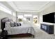 Bright main bedroom with large windows and a wall-mounted TV at 12594 Tidecrest Dr, Fishers, IN 46037