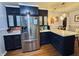 Modern kitchen with dark cabinets, granite countertops, and stainless steel appliances at 74 Morgan St, Danville, IN 46122
