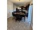 Eat-in kitchen with dark cabinets and granite-top island at 428 N Wyndstone Way, Fortville, IN 46040