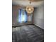 Bright bedroom with a large window, plush carpeting, and a unique light fixture at 428 N Wyndstone Way, Fortville, IN 46040
