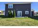 House back with patio and evergreen trees at 428 N Wyndstone Way, Fortville, IN 46040