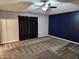Spacious bedroom with gray carpet and blue accent wall at 428 N Wyndstone Way, Fortville, IN 46040