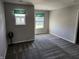 Spacious bedroom with neutral carpeting and two windows at 428 N Wyndstone Way, Fortville, IN 46040