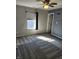 Spacious bedroom with a ceiling fan, window coverings, and carpeting at 428 N Wyndstone Way, Fortville, IN 46040