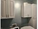 Laundry room with white cabinets and a front load washer at 428 N Wyndstone Way, Fortville, IN 46040