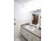 Bathroom with white vanity, a single sink, and tiled walls at 2212 Larita Ln, Anderson, IN 46017
