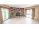 Gathering room with tile floors, fireplace and sliding glass doors at 2212 Larita Ln, Anderson, IN 46017