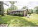 Brick ranch house with a large backyard, patio, and mature landscaping at 2212 Larita Ln, Anderson, IN 46017