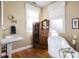 Elegant bathroom with clawfoot tub, antique cabinet, and modern sink at 10510 N County Road 650 E, Brownsburg, IN 46112