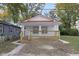 Charming craftsman style home with red metal roof and front porch at 1208 W 18Th St, Indianapolis, IN 46202