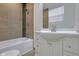 Updated bathroom with white vanity, tub, and tile surround at 1208 W 18Th St, Indianapolis, IN 46202