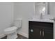 Updated bathroom with white vanity, toilet and shower at 1208 W 18Th St, Indianapolis, IN 46202