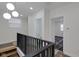 Upper hallway with black railing and views of bathroom and bedroom at 1208 W 18Th St, Indianapolis, IN 46202