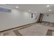 Bright finished basement with neutral walls, tile flooring, and a modern staircase at 1208 W 18Th St, Indianapolis, IN 46202