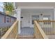 Front porch with wood railings and gray decking at 1208 W 18Th St, Indianapolis, IN 46202