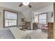 Bright bedroom with two windows, built-in shelving, and a rocking chair at 6971 Lynx Dr, Nineveh, IN 46164