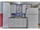 Small kitchen in the basement with white cabinets and appliances at 6971 Lynx Dr, Nineveh, IN 46164