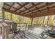 Covered deck with seating area and wooded view at 6971 Lynx Dr, Nineveh, IN 46164